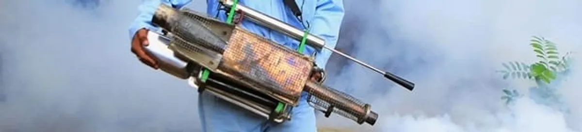 Fumigation technician using a fogger for deep pest treatment in Syracuse, NY