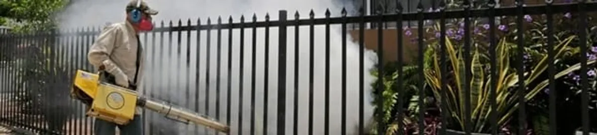 Mosquito control technician fogging a yard perimeter for mosquito reduction in Syracuse, NY